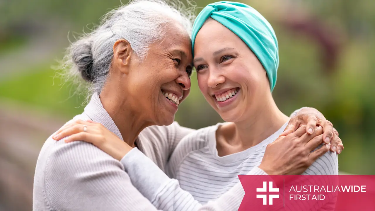 A woman with cancer being embraced by another woman